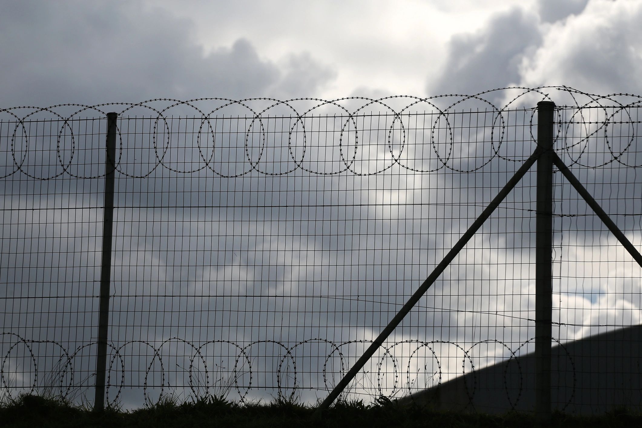 Dramatic perimeter fence symbolizing layered protection and boundary control