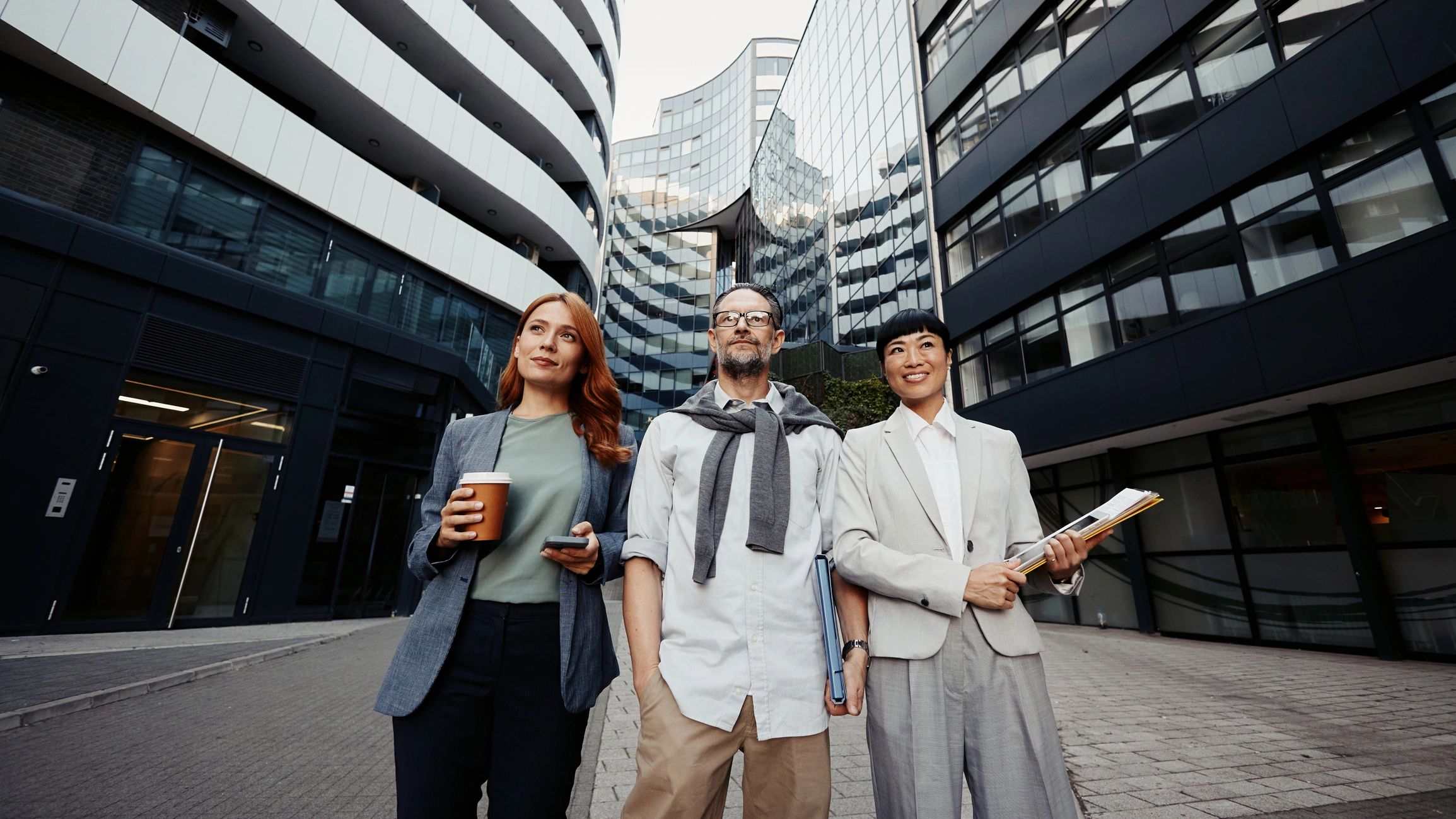 Professional cybersecurity consulting team discussing strategy in an urban business setting